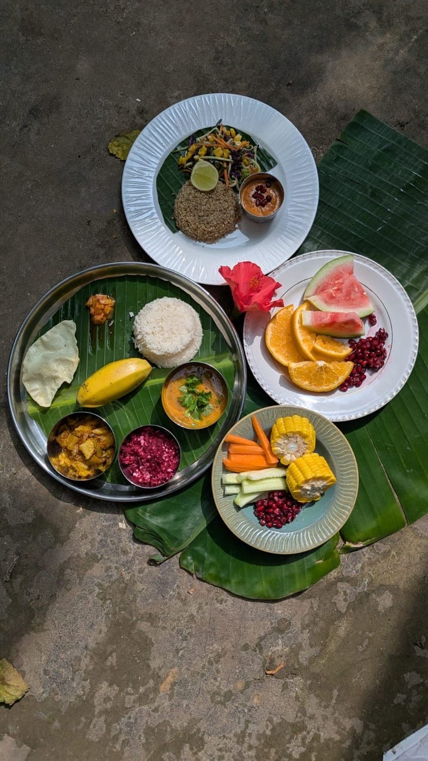 An overhead spread of South Indian dishes and fruit