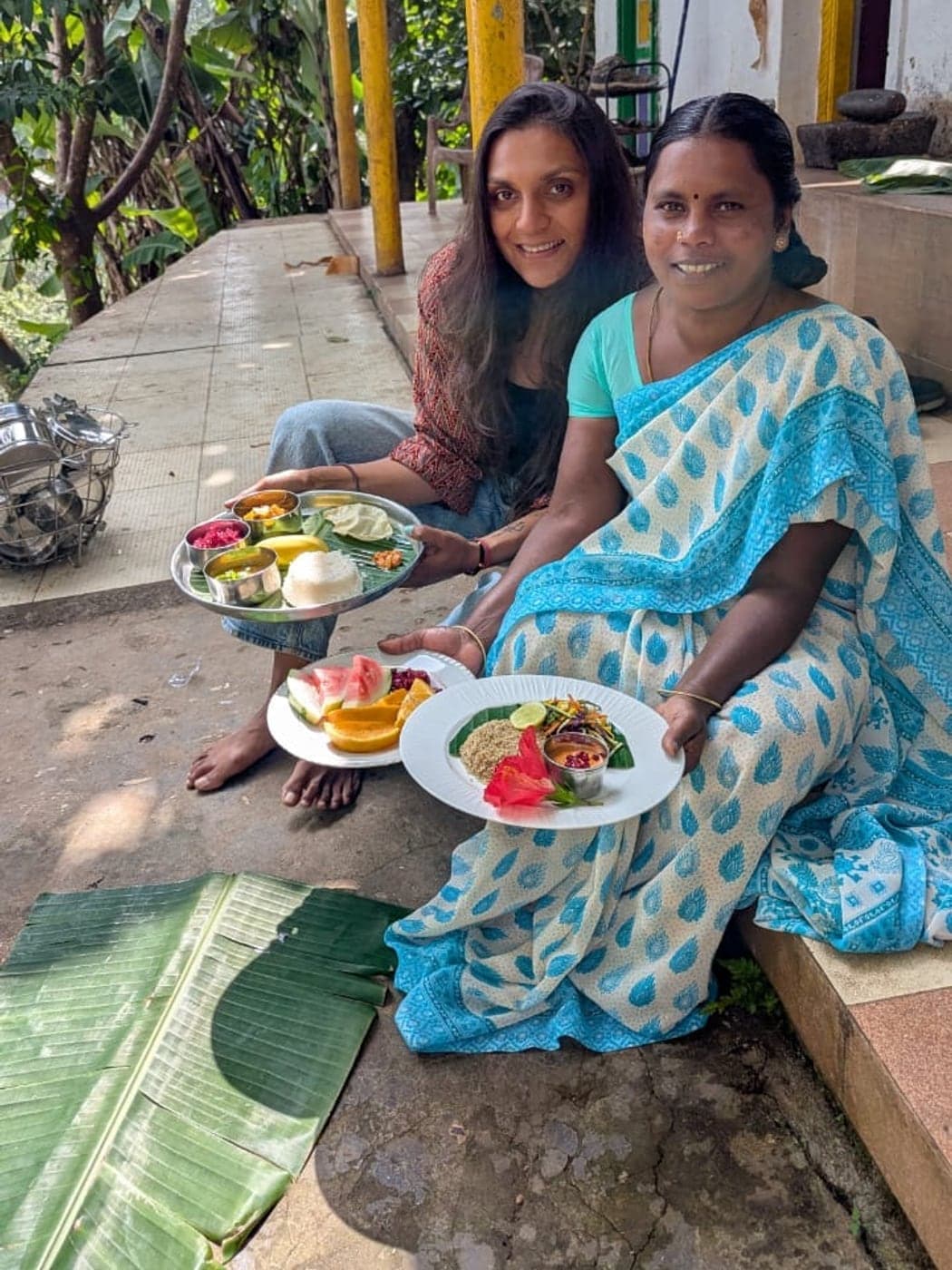 Rani Akka and Nikhita, who cook for the table, together in the kitchen