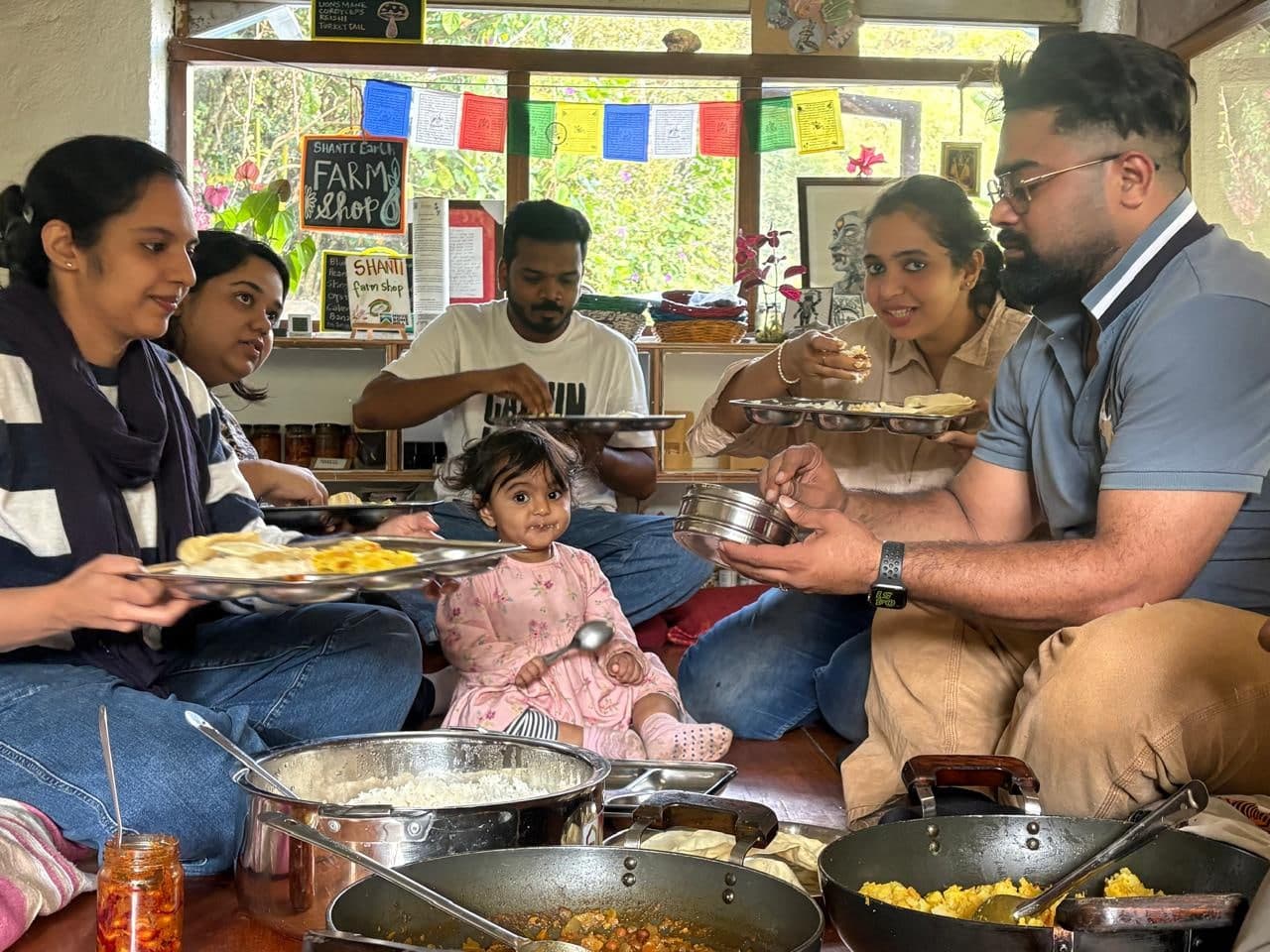 Guests and household sharing a meal together on the floor