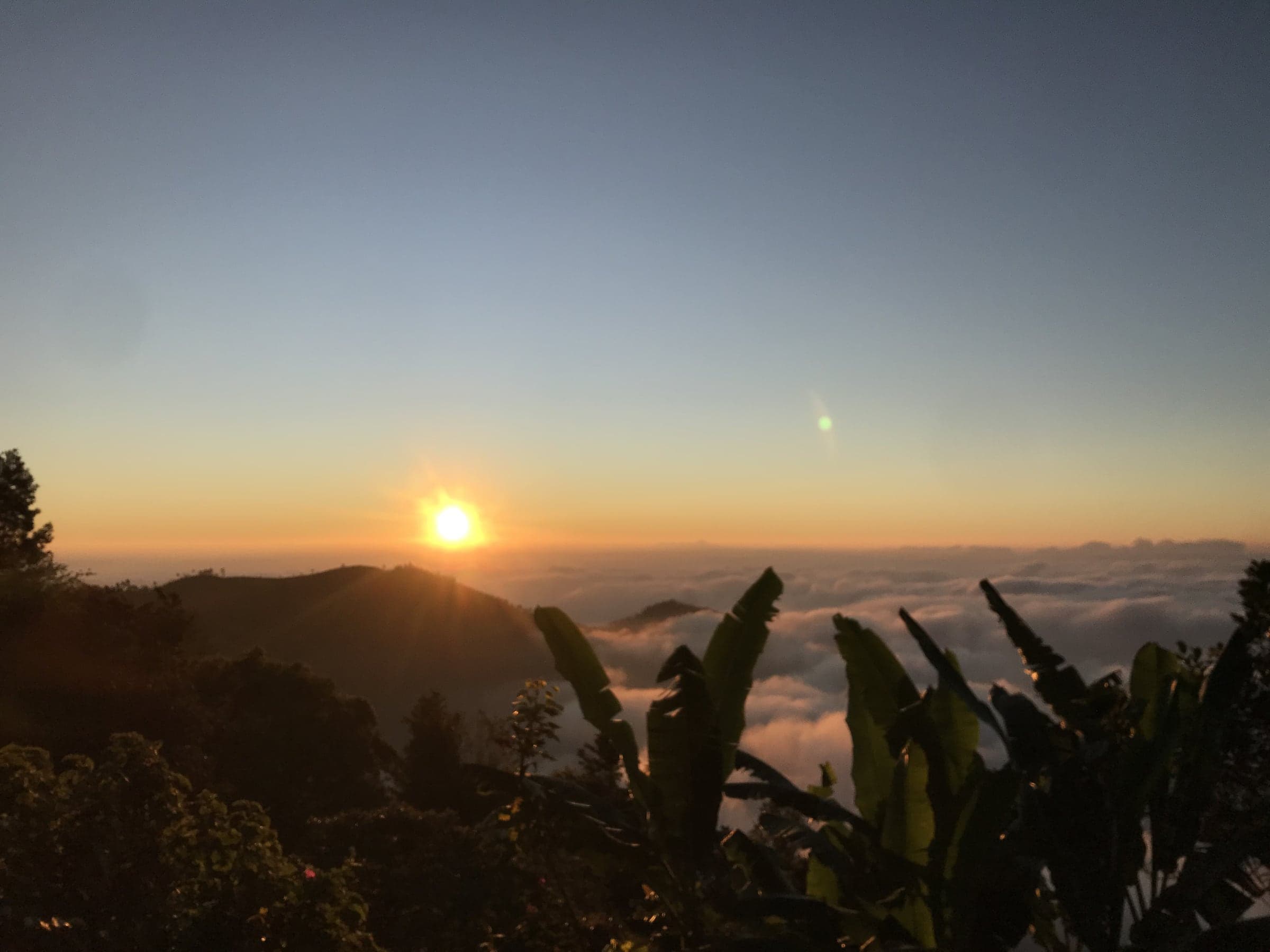 The sun setting in gold over the layered hills