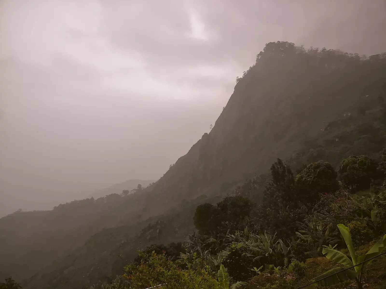 Layered, misty ridges of the Western Ghats falling away into the distance