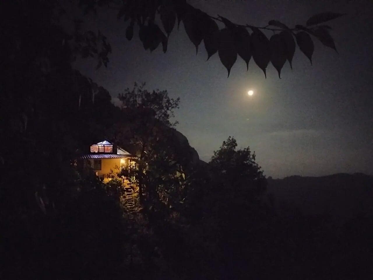 Stars over a cottage at night, when the mist allows