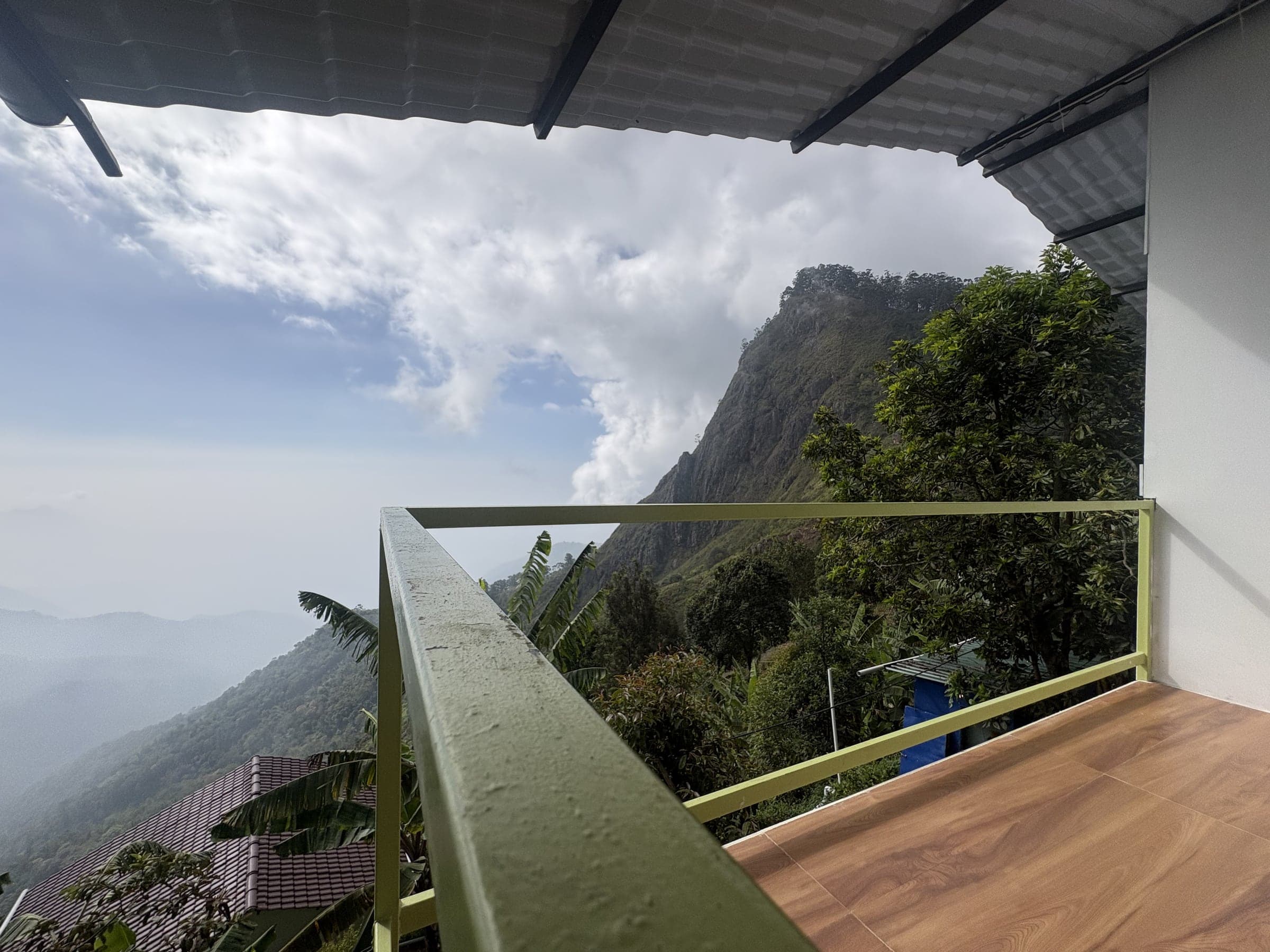 A cottage balcony opening into the green